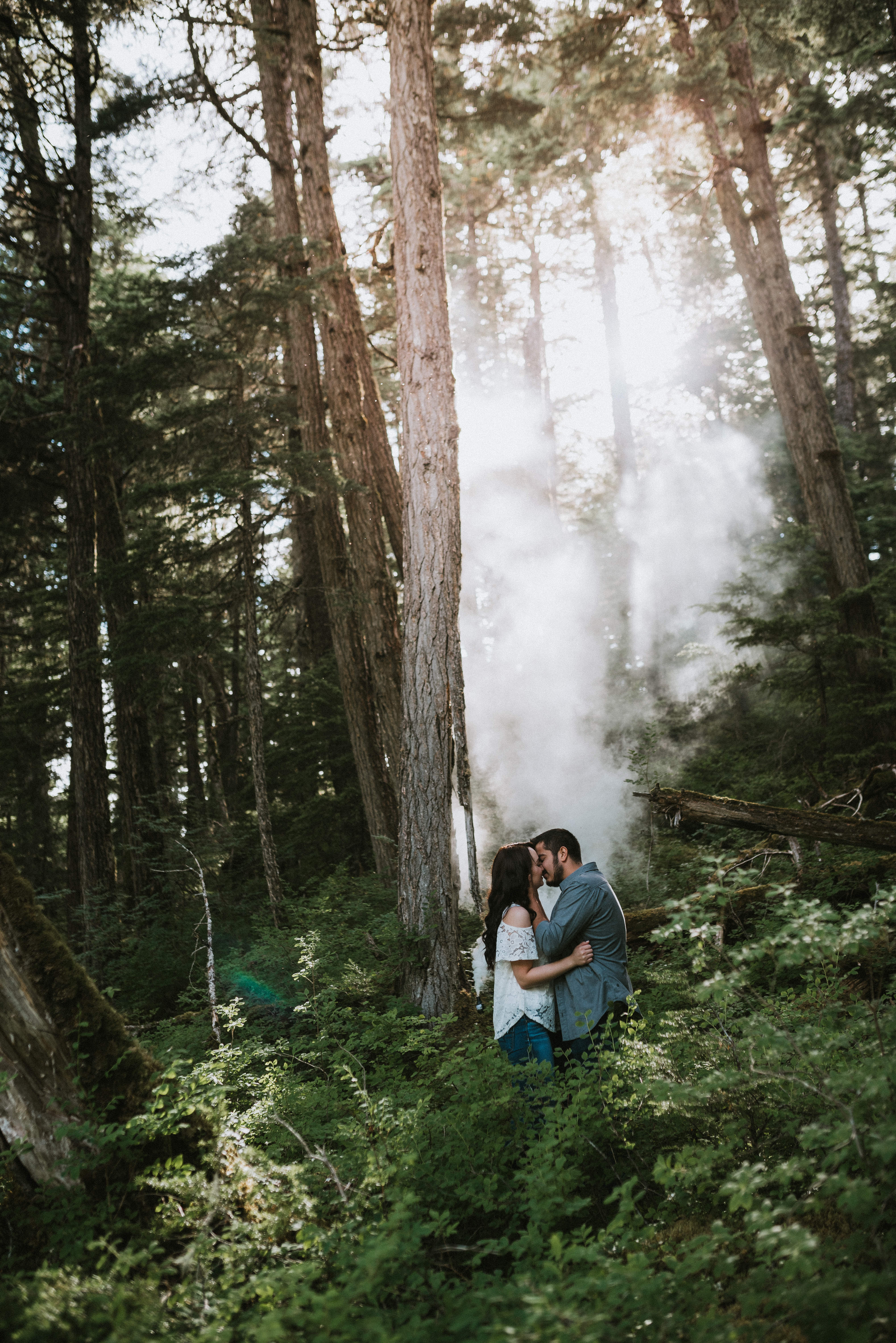 Couple kissing with a smoke bomb during their Girdwood Alaska Engagement Photos