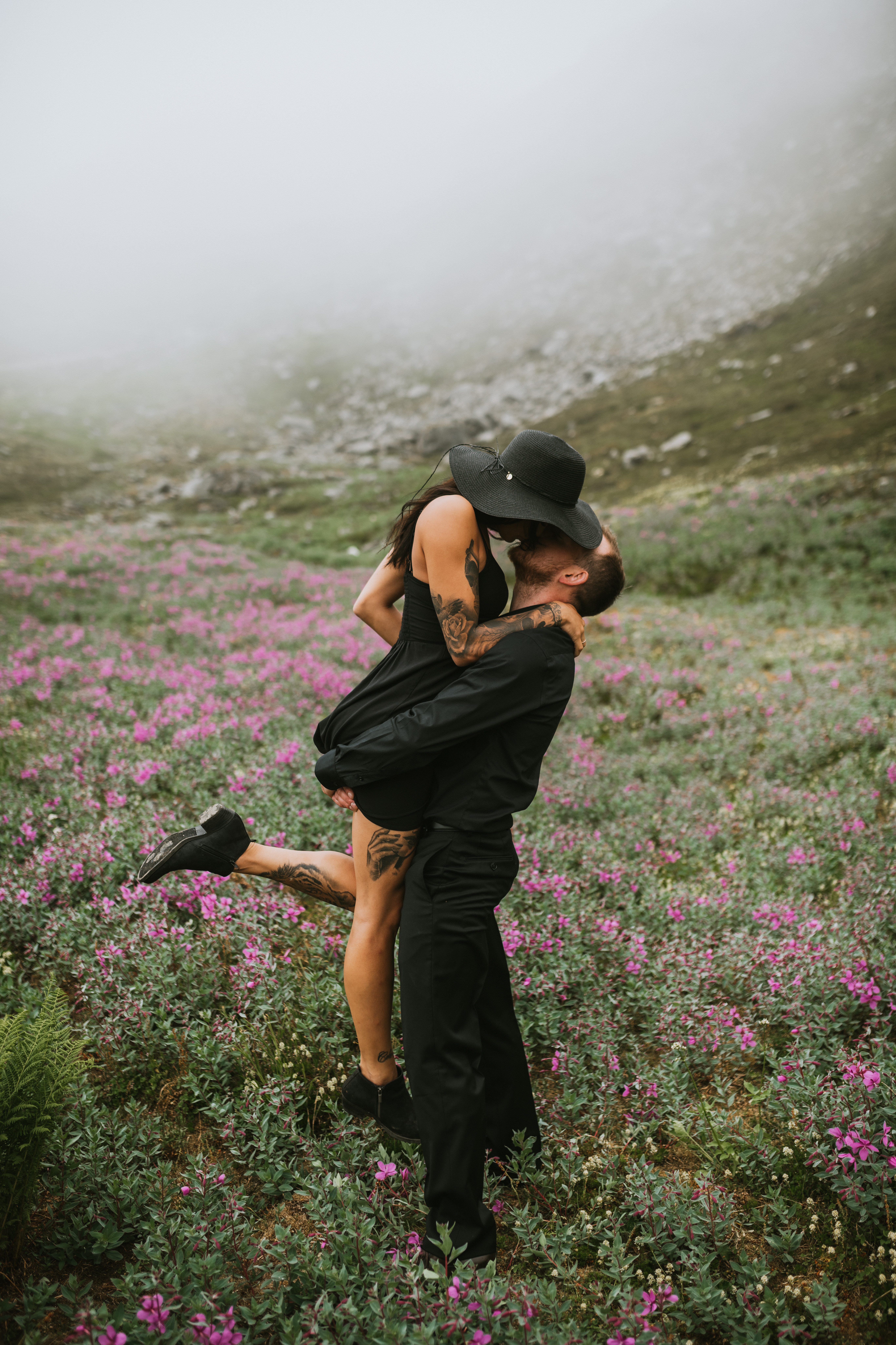Couple kissing in the fireweed up Hatcher Pass during their Engagement photos in Alaska