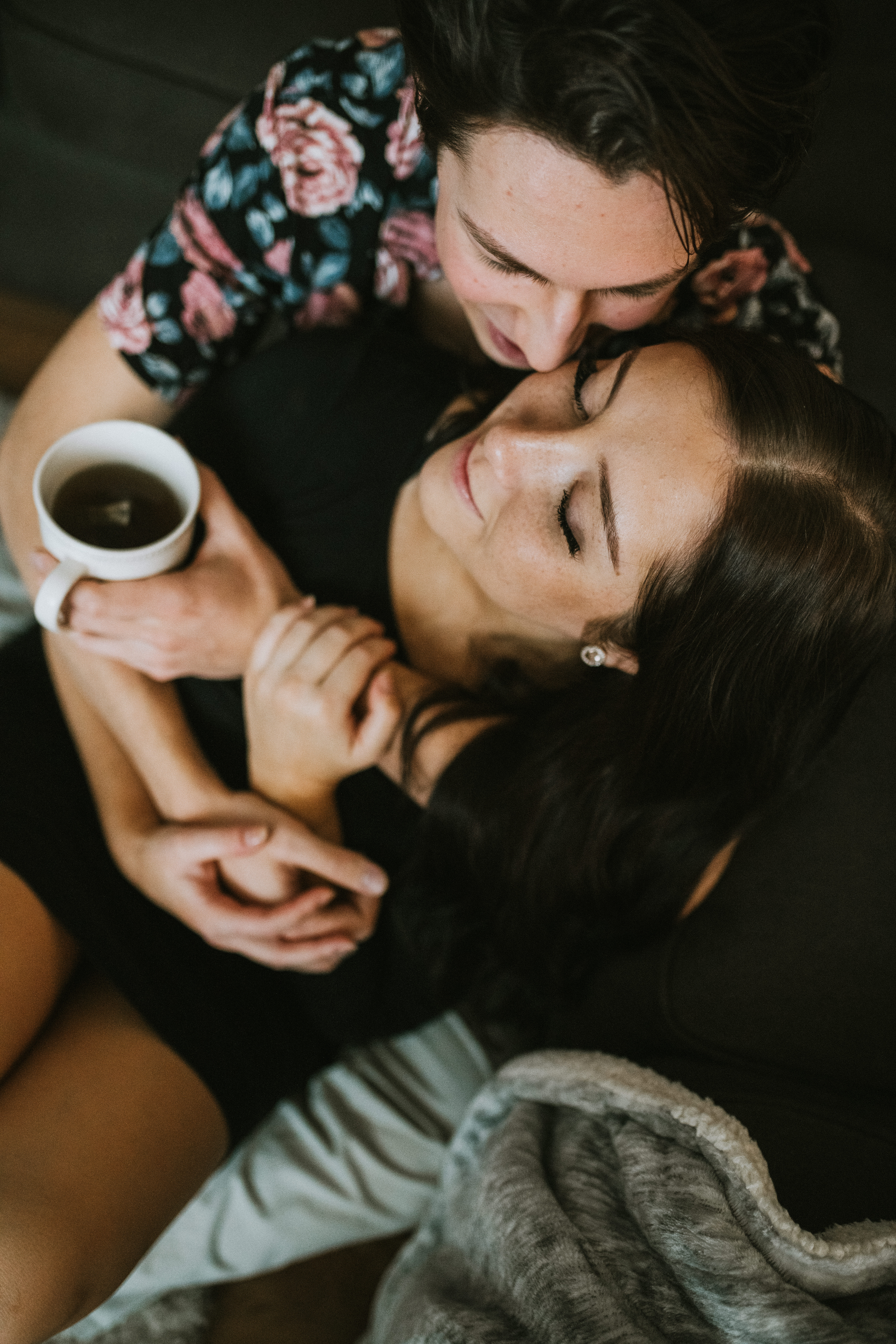 Snuggly in home engagement session with coffee