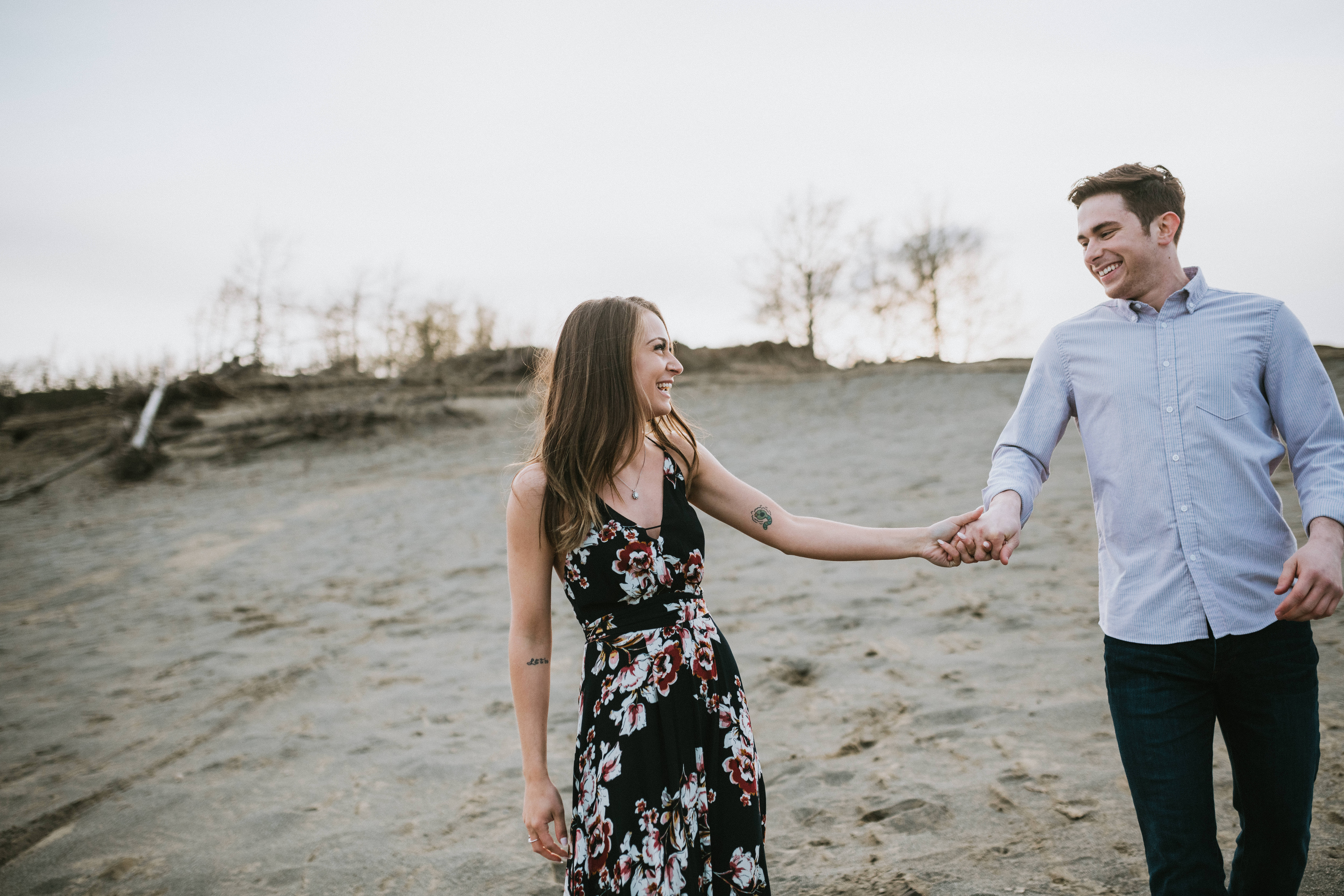 Couple walking along Kincaid Sand Dunes in Alaska during their engagement photos