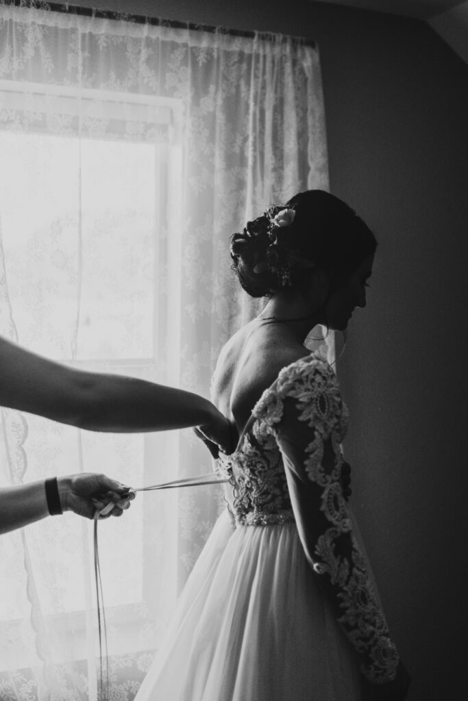 A person putting on a dress to elope in Alaska.