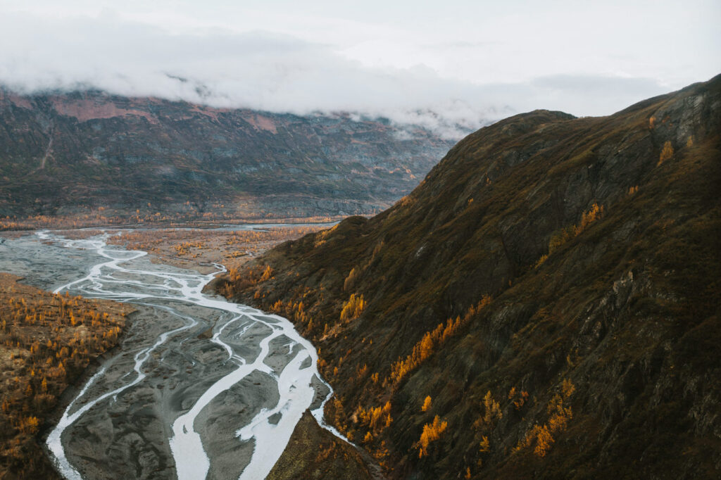 An aerial view of a river in the mountains during an Alaska elopement.