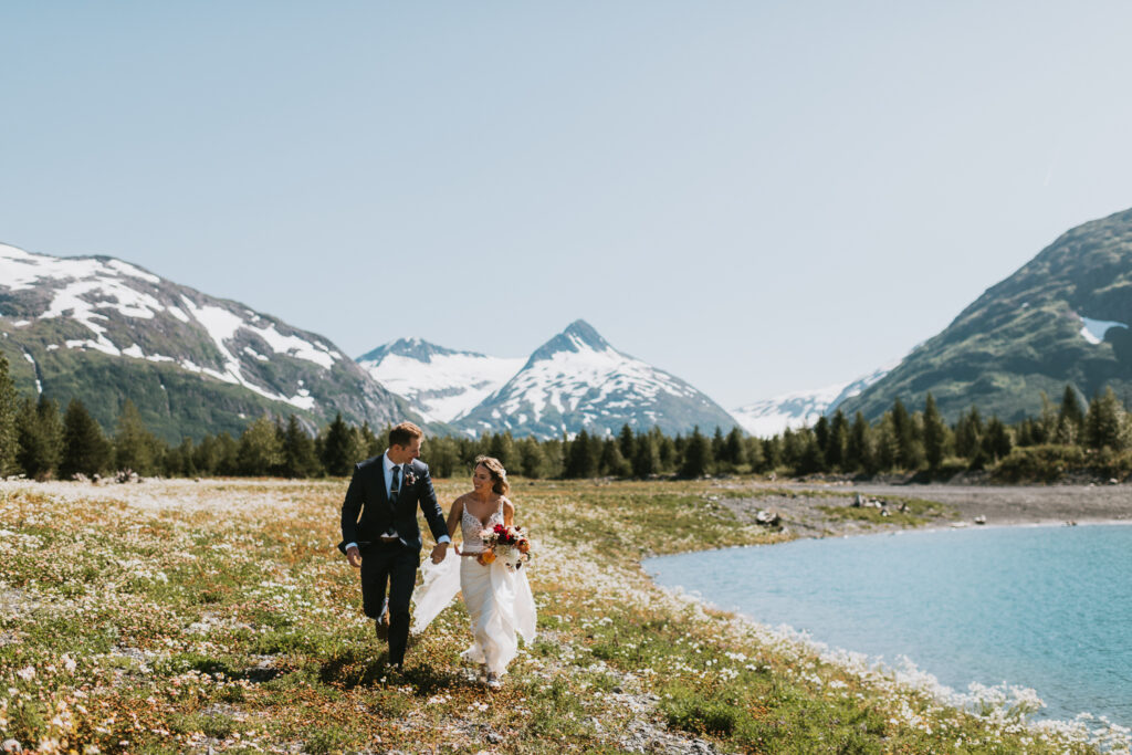 A man and woman elope by a lake in Alaska.