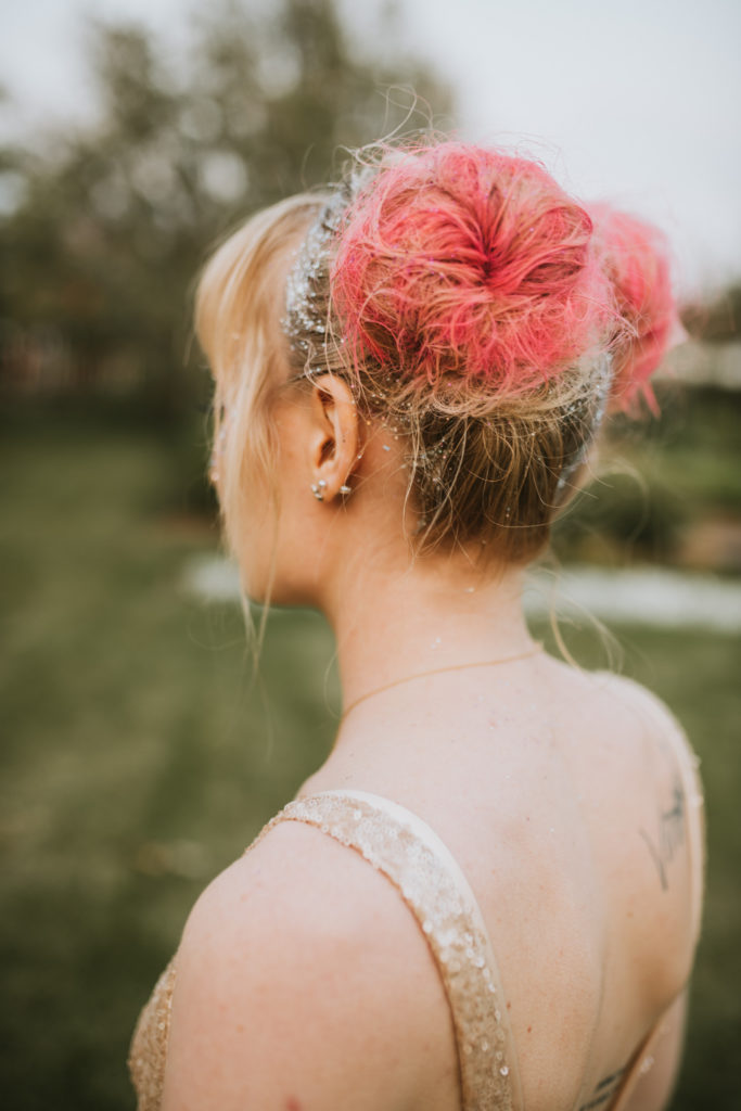 Glittery pink space buns for an off-beat bride carnival theme wedding