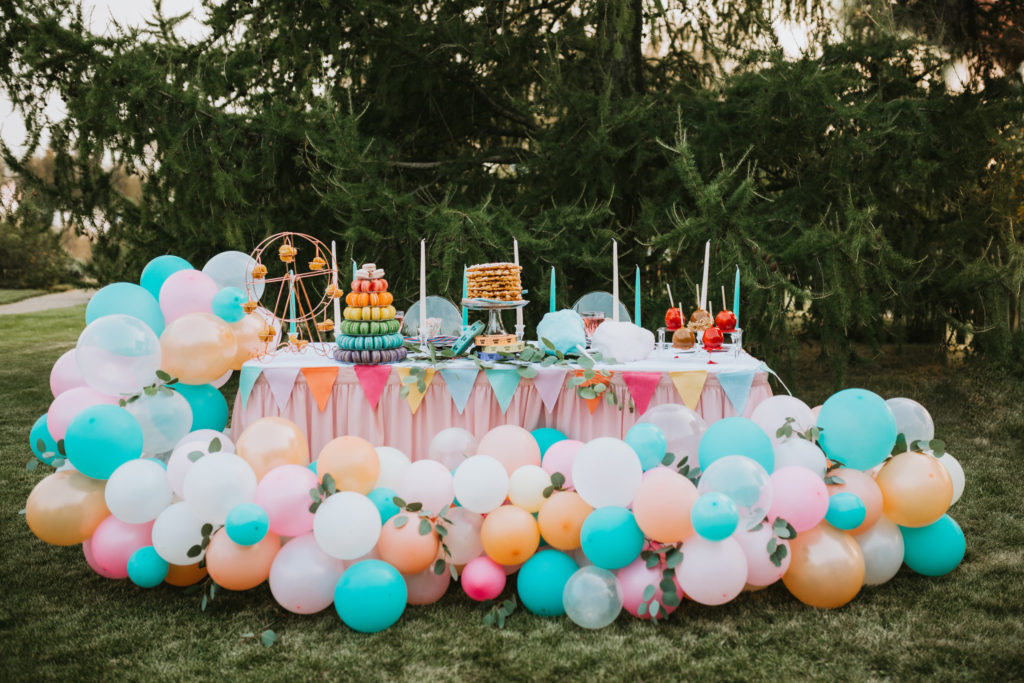 Colorful tablescape with balloons and fair food at alaska state fair 