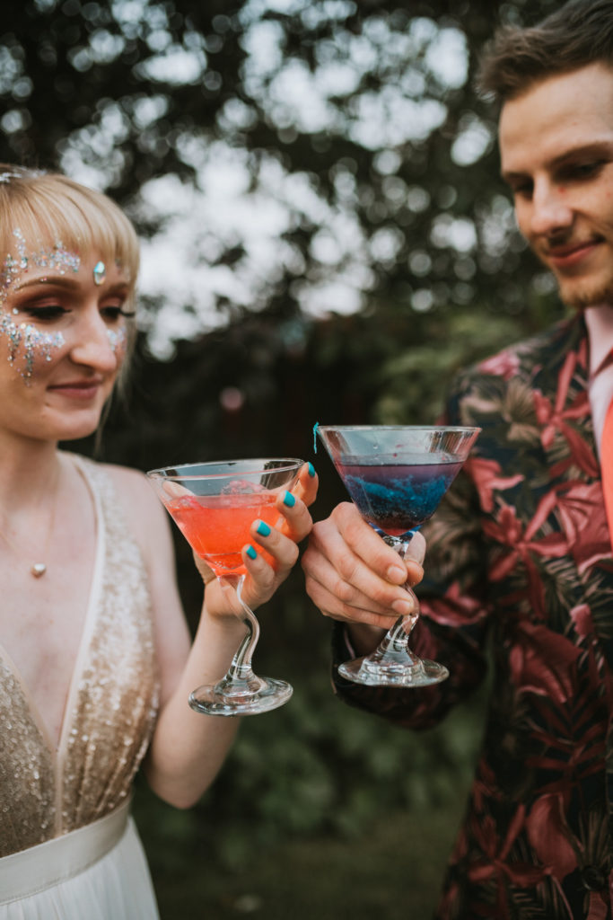 Bride and groom cheersing their cotton candy cocktails at their elopement