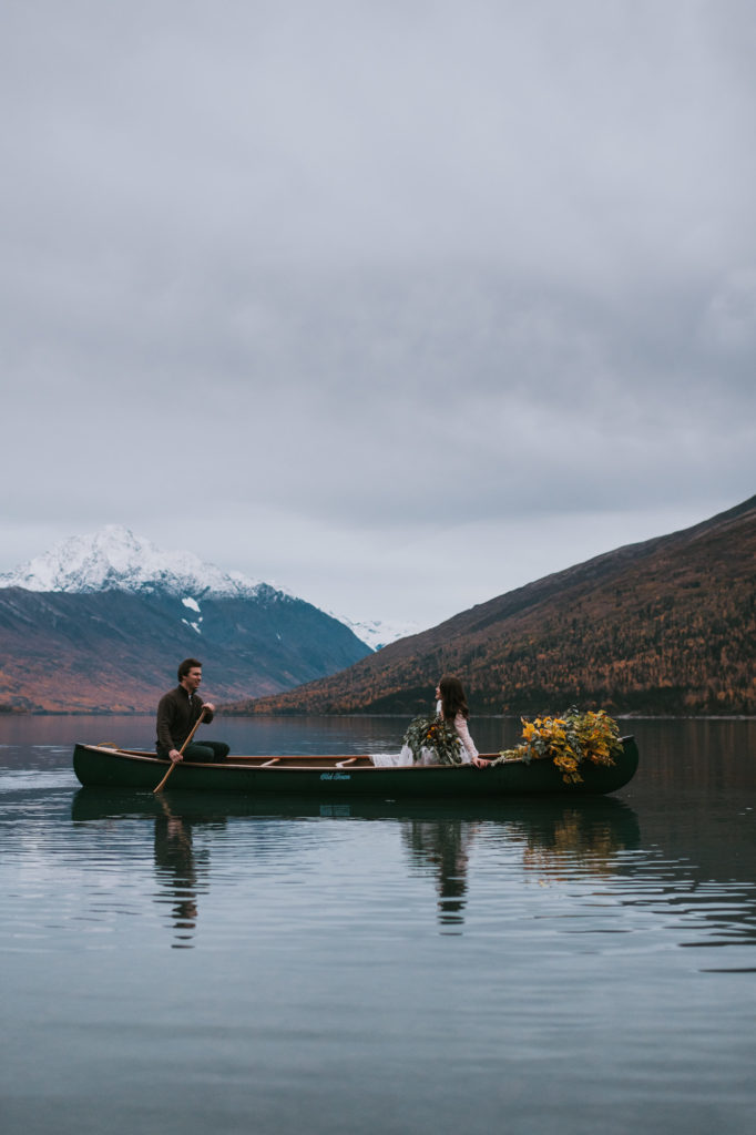 Couple canoeing out on their elopement day on eklutna lake