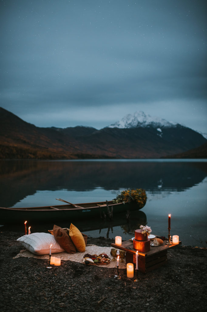 Candlelit picnic on eklutna lake for elopement with lake and mountain backdrop