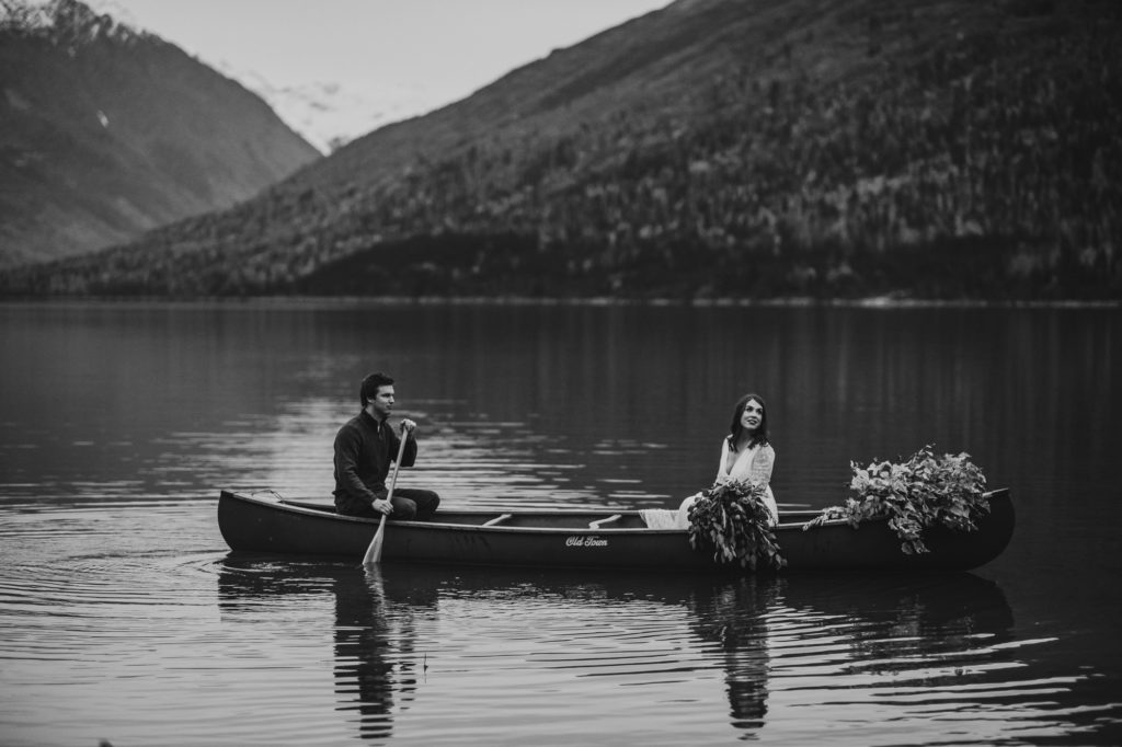 Black and white photo of a couple in a canoe on eklutna lake