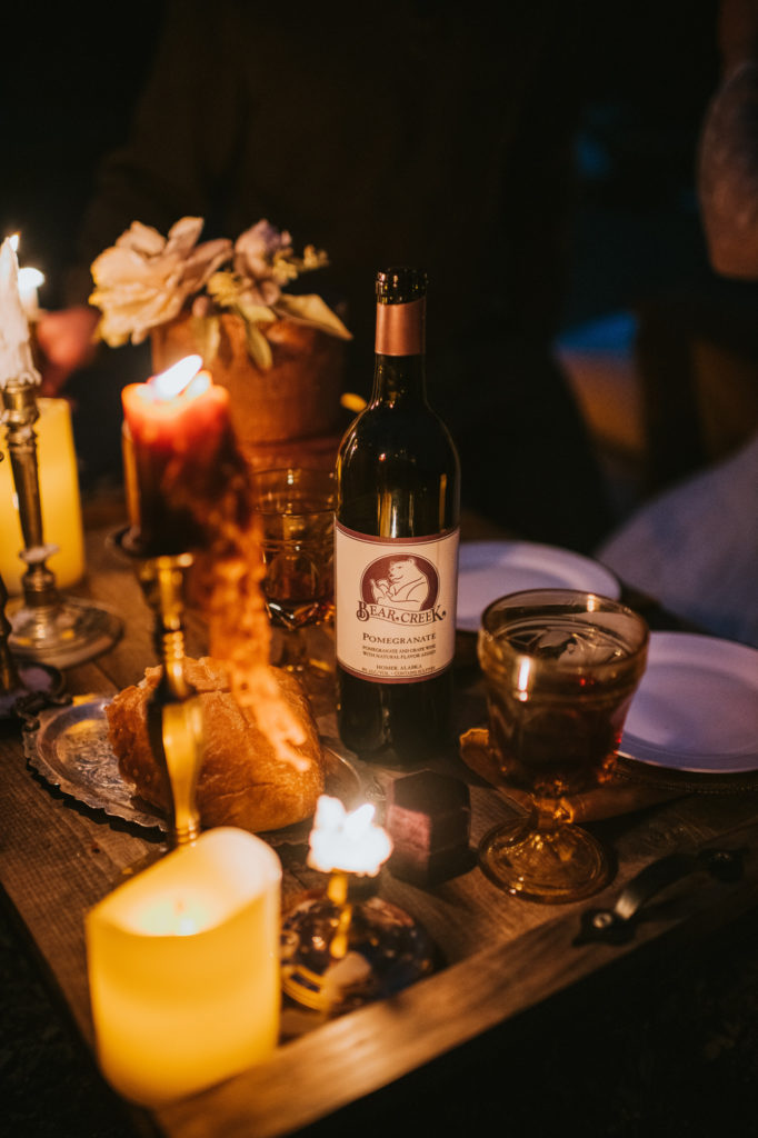 Detail photo of candle lit picnic of bear creek winery and cake
