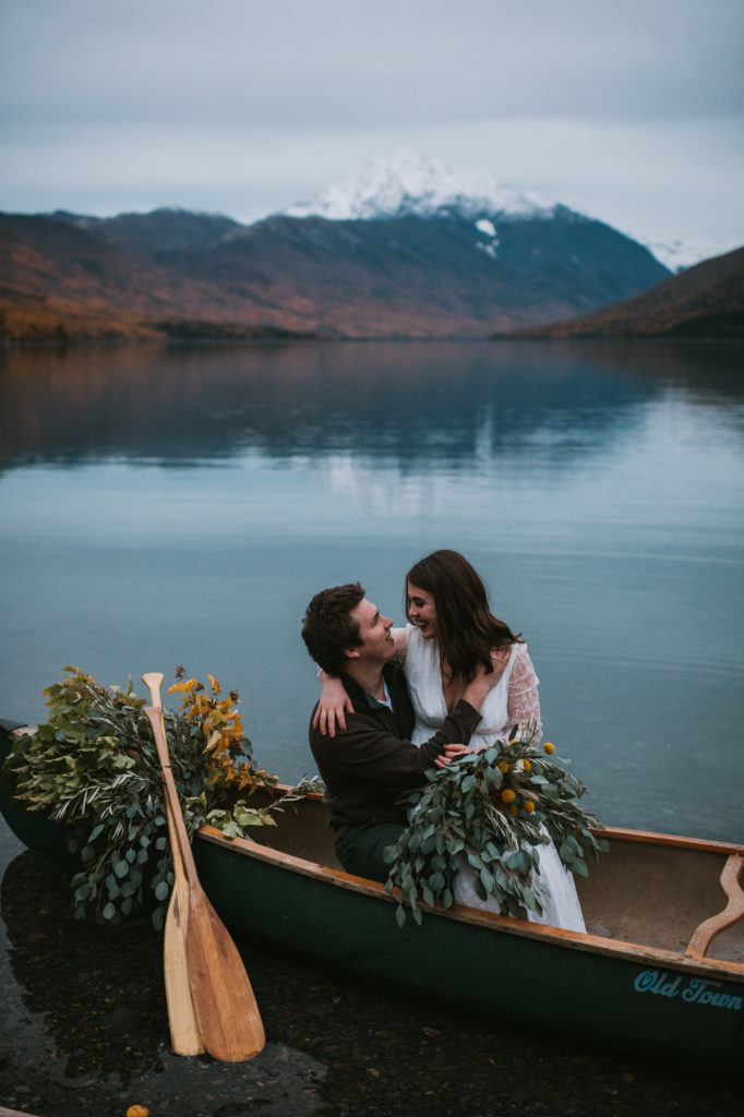 Couple snuggling in a canoe on their elopement day