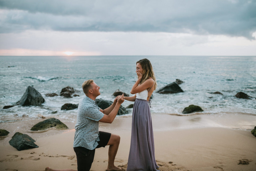 couple standing on beach during her boyfriends proposal