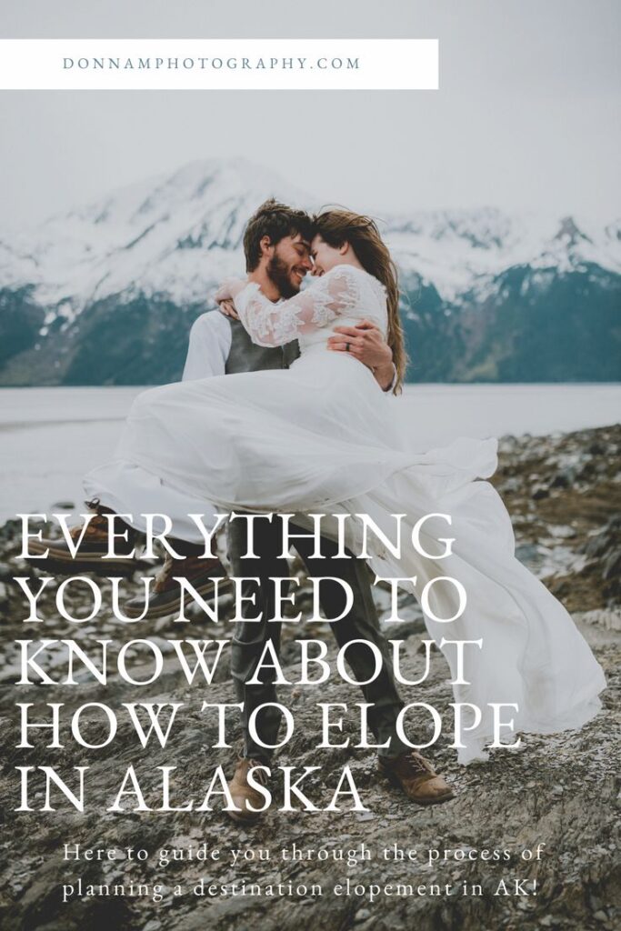 A couple embraces on a rocky coastline with snow-capped mountains in the background. Text: "Everything You Need to Know About How to Elope in Alaska.