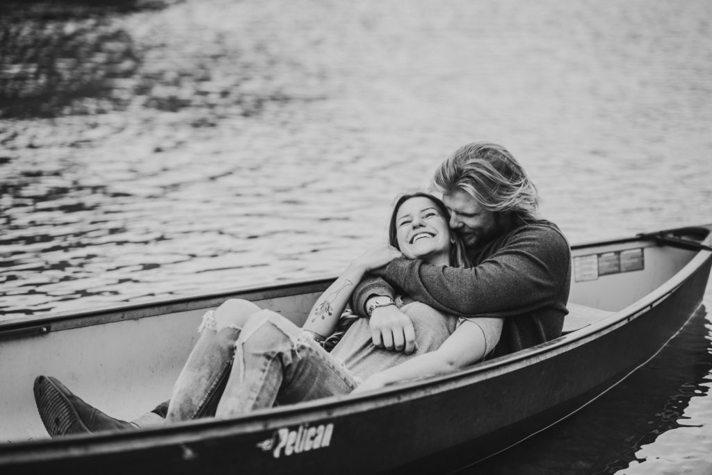 Couple in a canoe at Eklutna Lake with a mountain backdrop