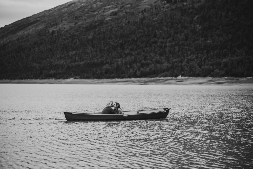 Couple in a canoe at Eklutna Lake with a mountain backdrop